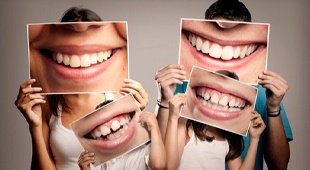 family holding posters of mouth in front of their faces