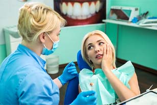 Woman in dental chair with a toothache