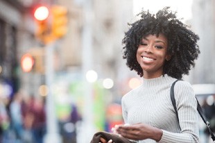 woman smiling while outside 