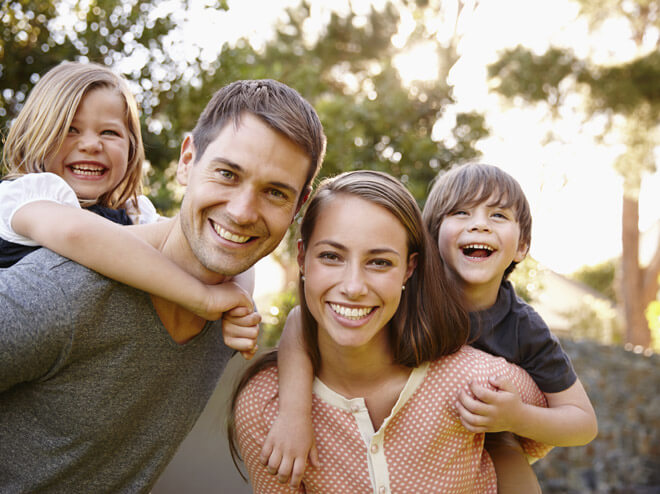 family of four smiling