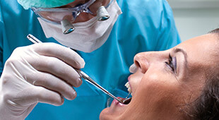dentist checking woman's smile