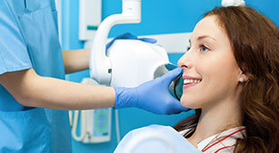 woman smiling while getting x-ray