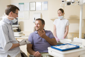 Man talking to dentist about dental implants