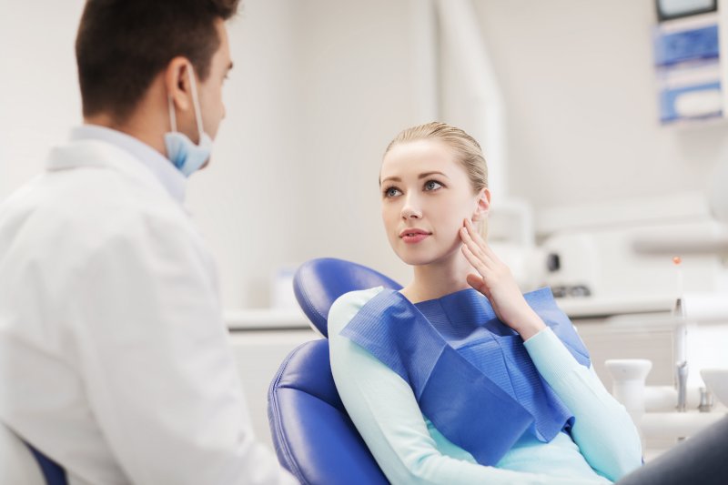 A teen girl seeing her dentist for a tooth replacement