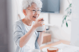 Woman with dentures eating breakfast